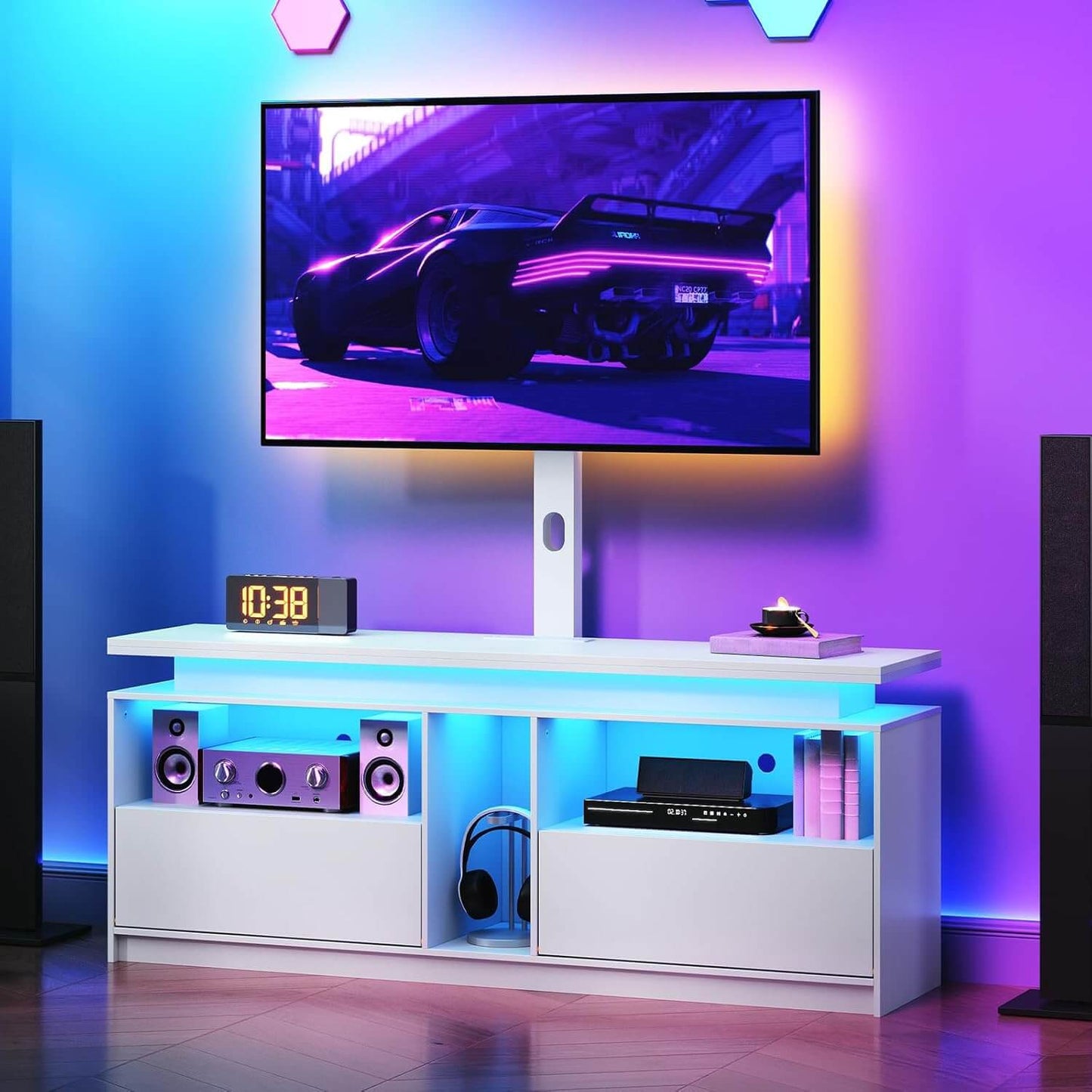 Modern entertainment console with TV and speakers in a room with colorful LED lighting.