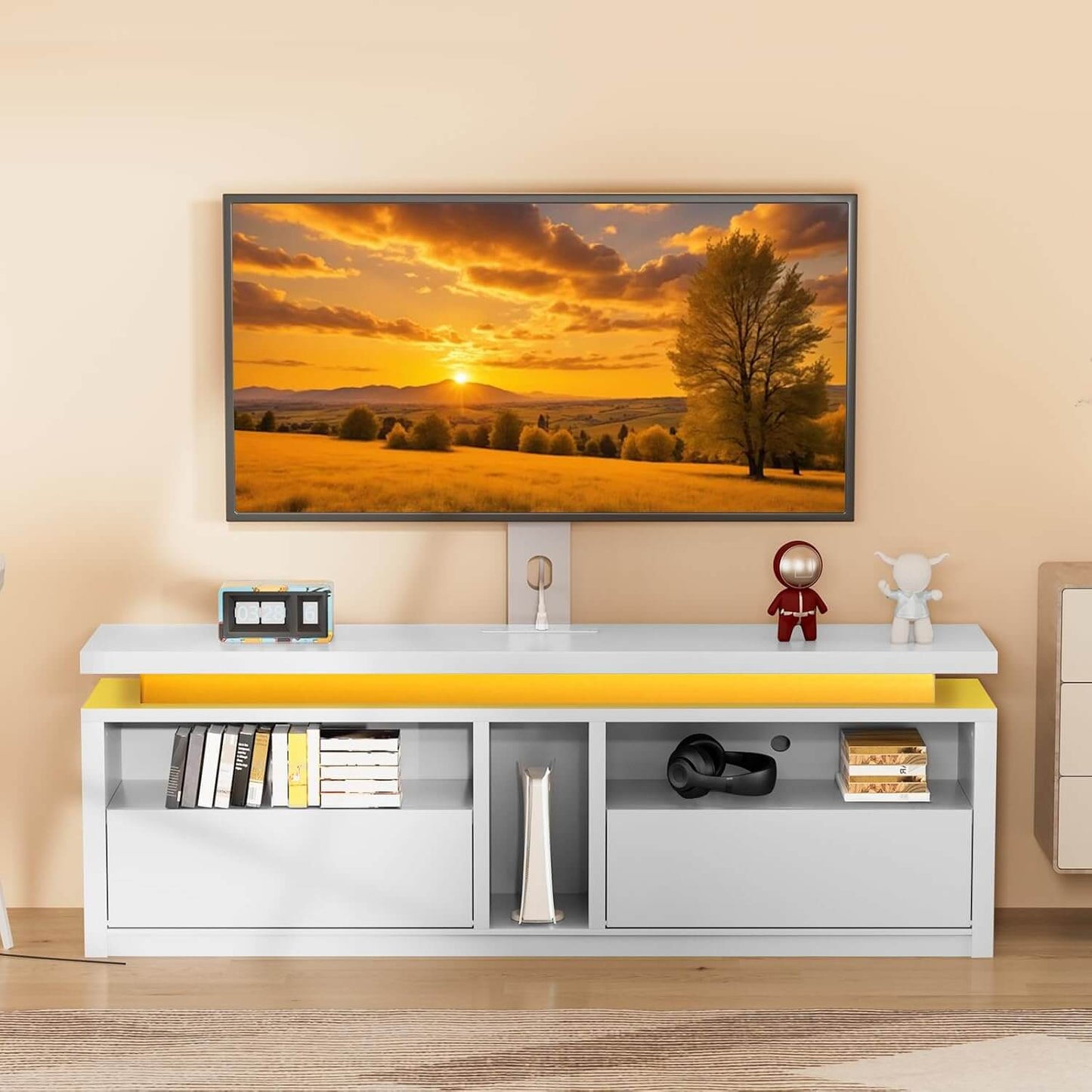 Modern TV stand with a television displaying a sunset scene, placed against a beige wall.