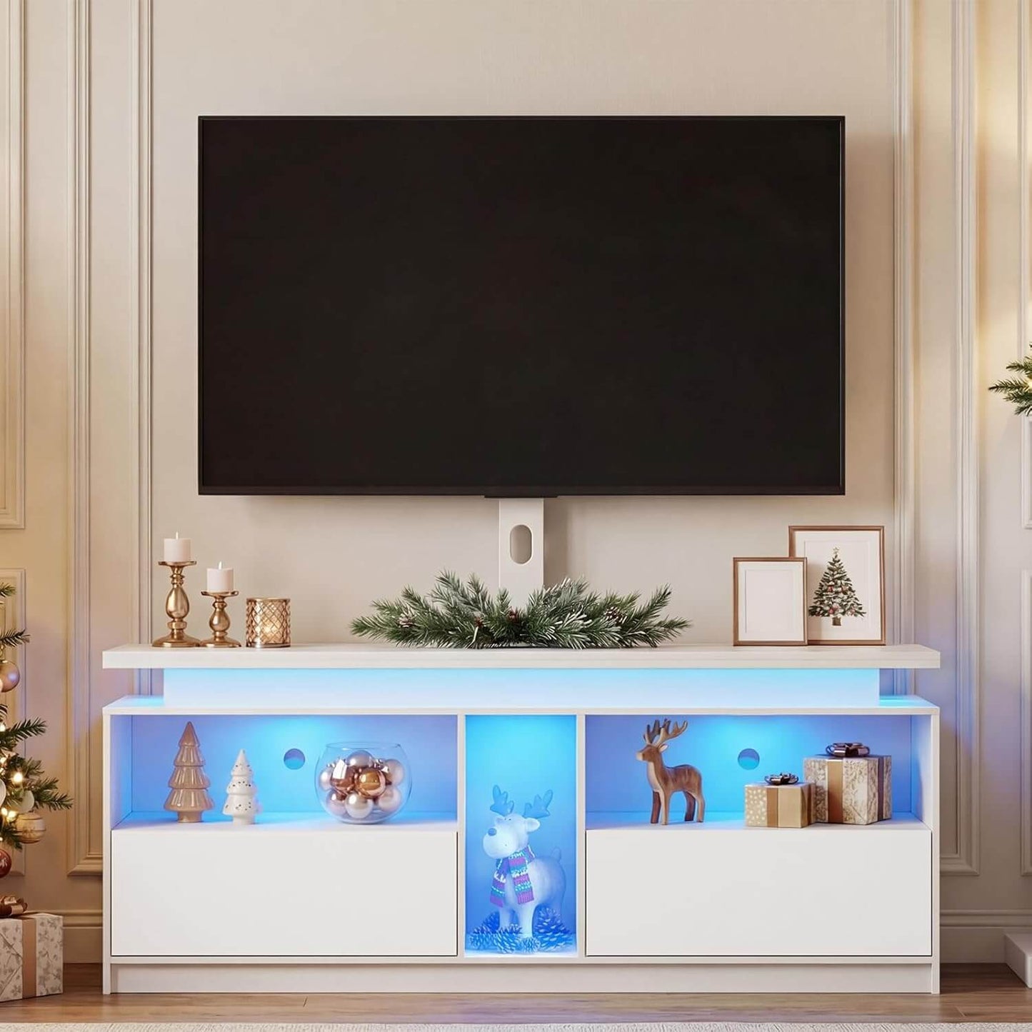 White entertainment console with LED lights displaying decorative items in a living room setting.