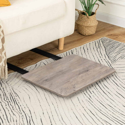 The grey wooden table folded completely flat and sliding smoothly into the narrow gap underneath a beige fabric sofa.