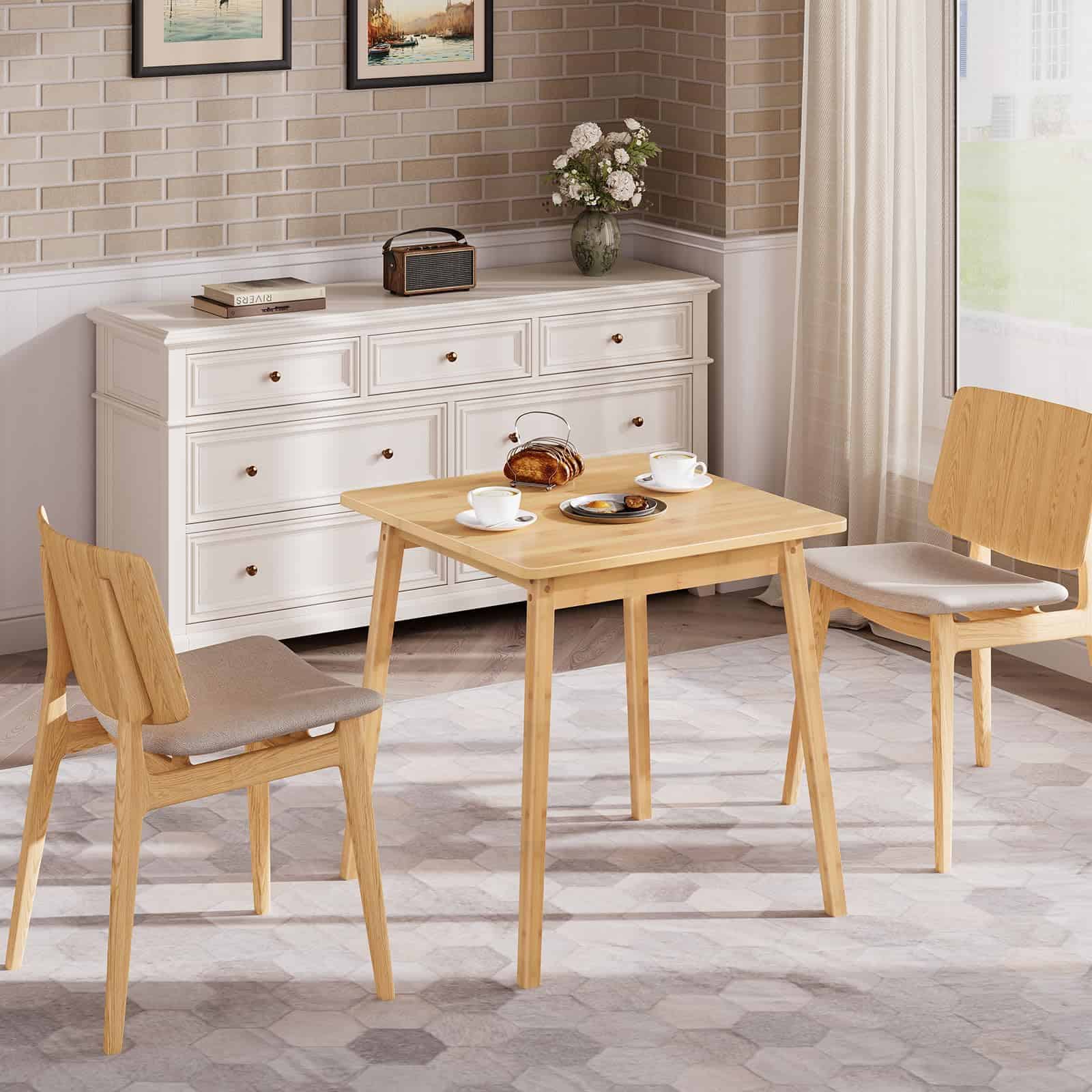 Freestanding small bamboo kitchen table used as a breakfast bistro table next to a white sideboard.