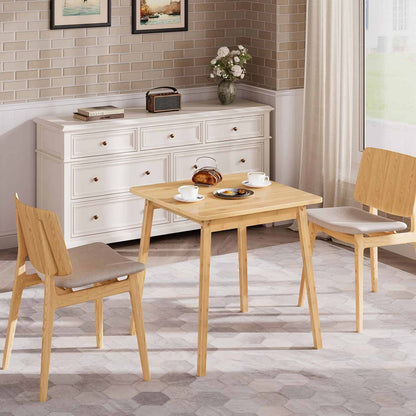 Freestanding small bamboo kitchen table used as a breakfast bistro table next to a white sideboard.