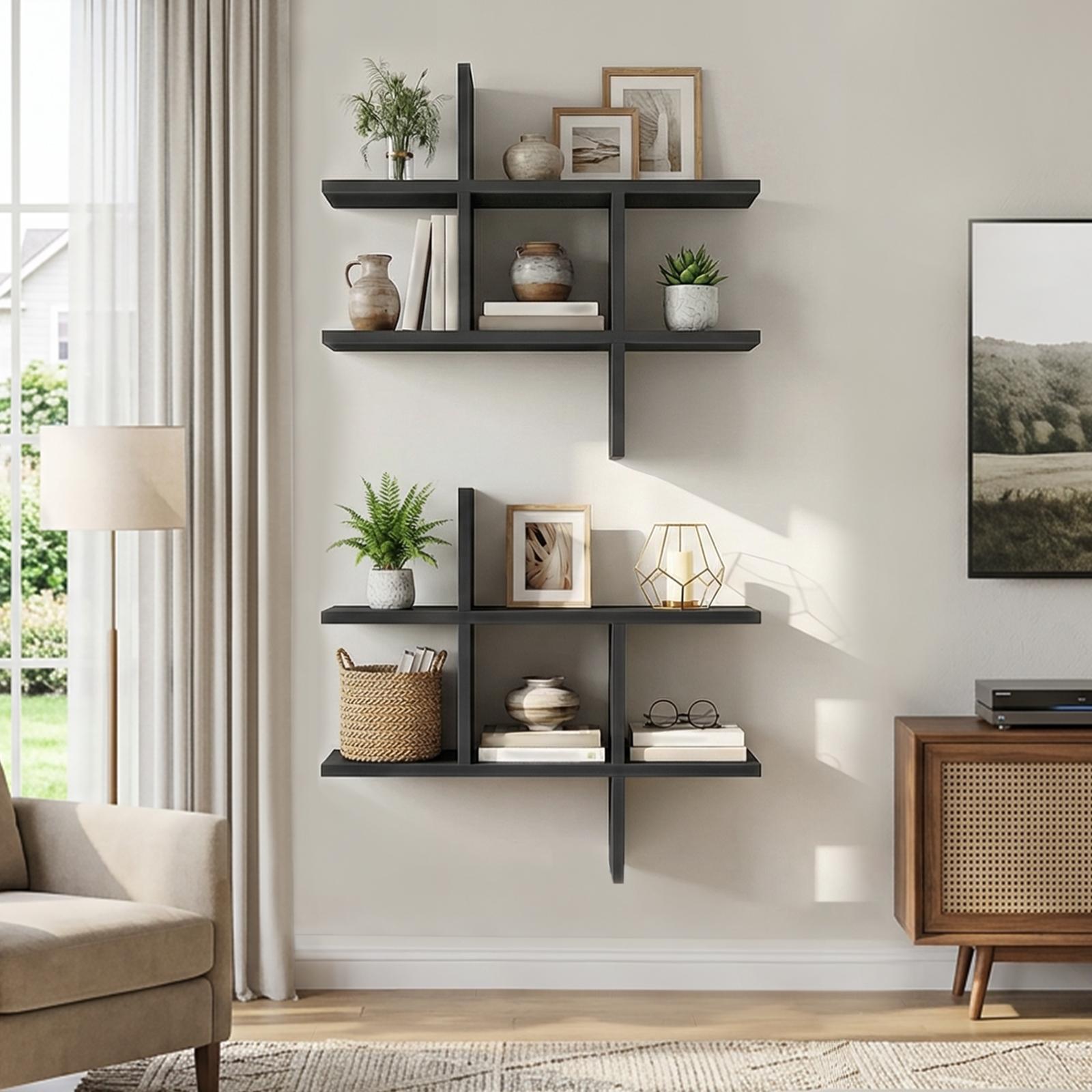 Two black intersecting floating wall units vertically stacked to create a tall display corner next to an armchair.