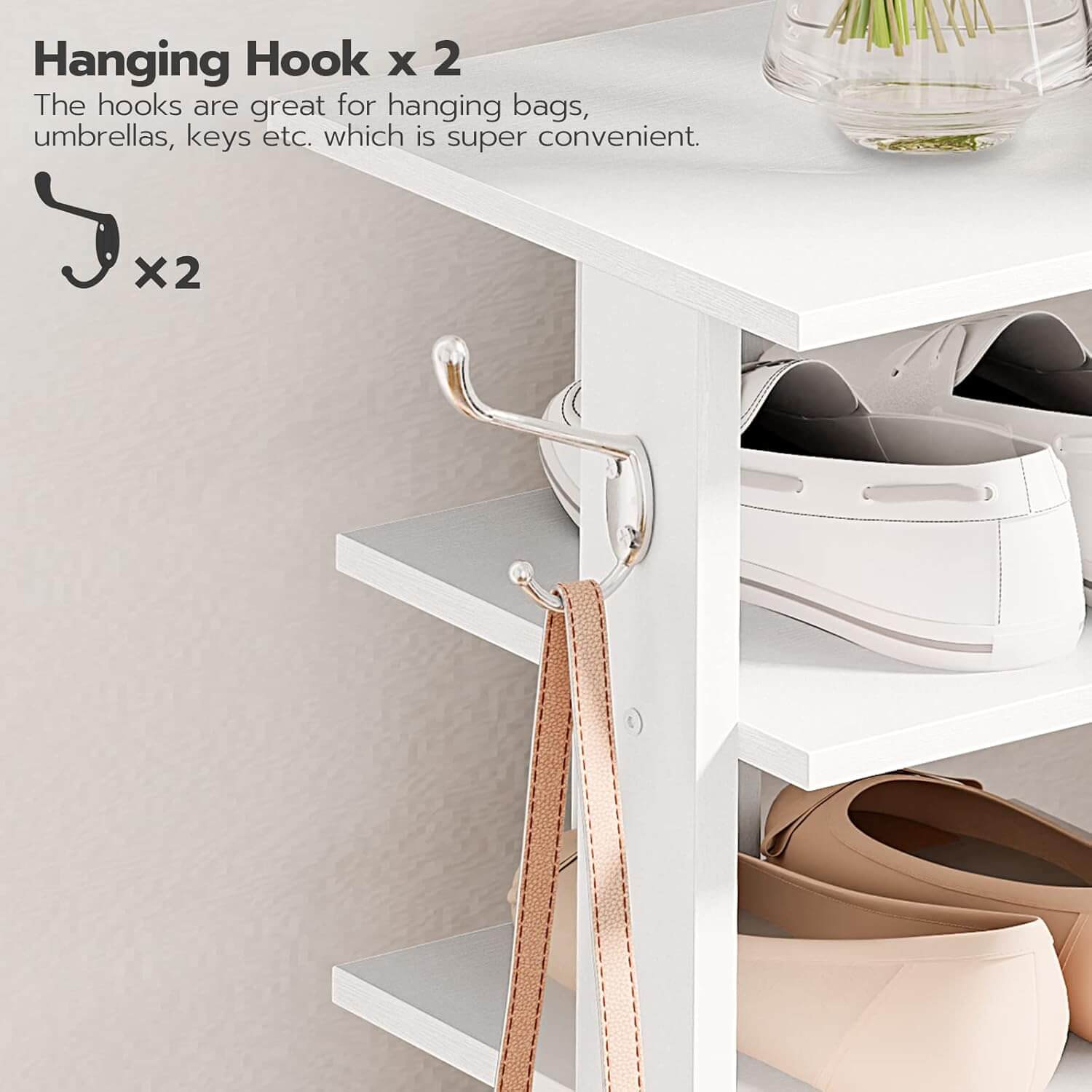 White cabinet with hanging hooks for bags, umbrellas, and keys on a light gray background.