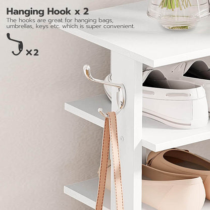 White cabinet with hanging hooks for bags, umbrellas, and keys on a light gray background.