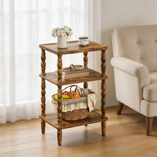 Vintage rustic 3-tier end table with elegant turned legs styled with flowers and coffee next to a cream armchair.