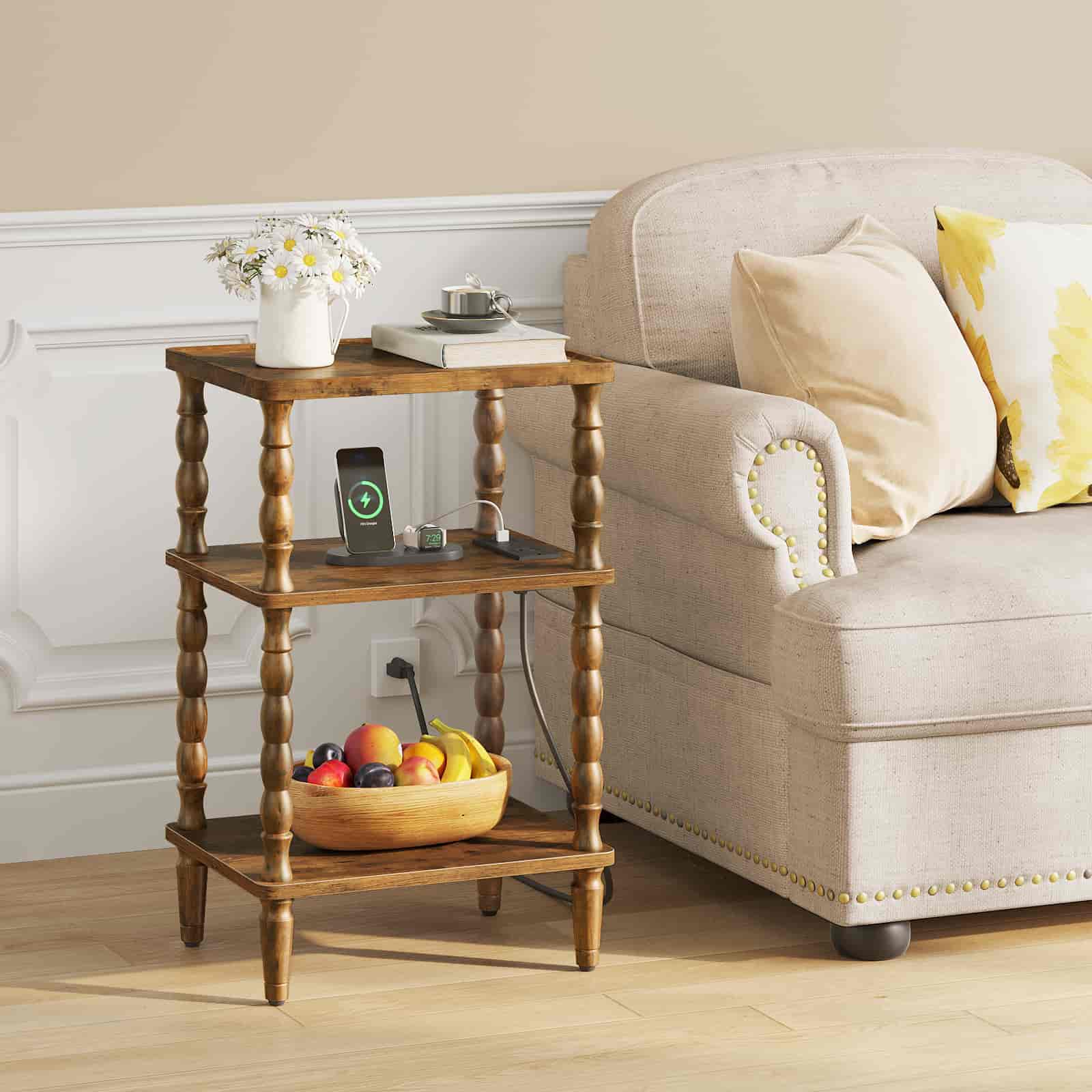Vintage rustic 3-tier end table with charging station placed next to a beige sofa, decorated with flowers and fruit.