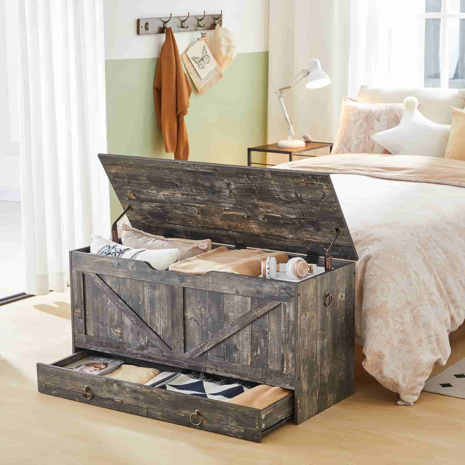 Vintage grey storage chest styled as a blanket box in a warm bedroom setting with open top lid.