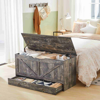 Vintage grey storage chest styled as a blanket box in a warm bedroom setting with open top lid.