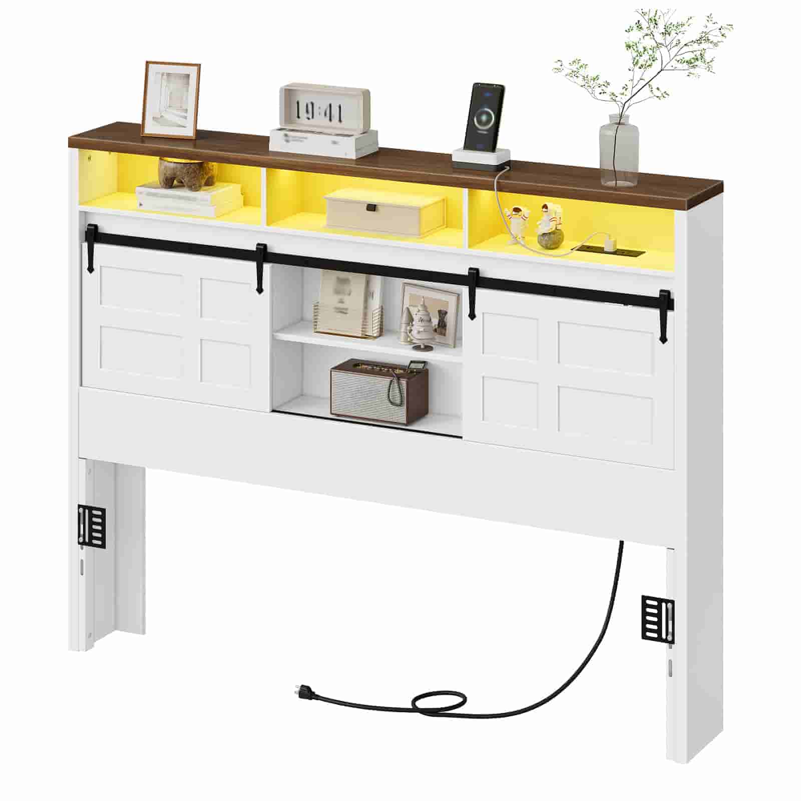 Studio shot of a white and brown wooden headboard featuring a built-in power strip and warm yellow top lighting.