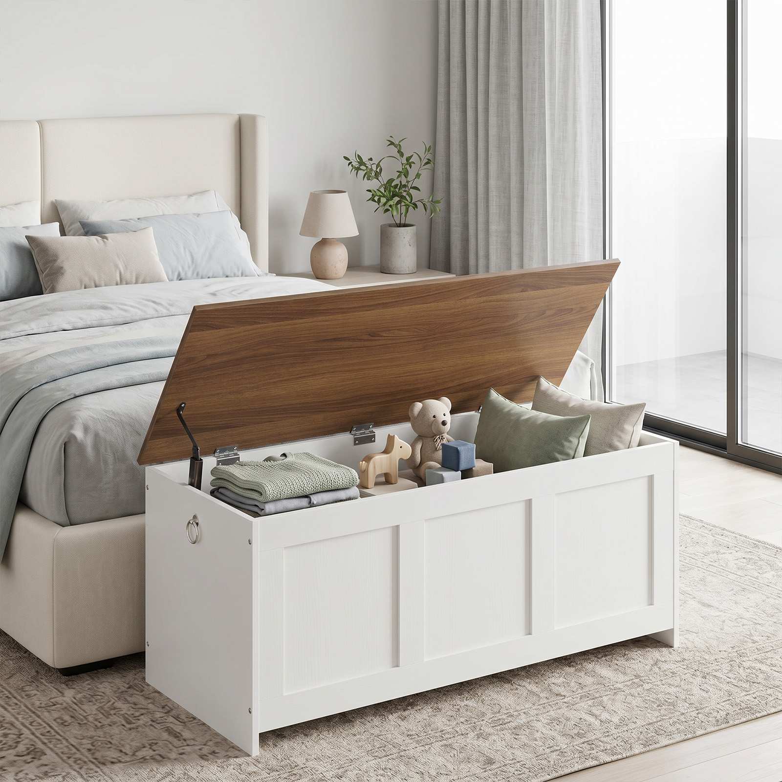 White farmhouse storage bench positioned seamlessly at the end of a bedroom bed with the brown wooden lid lifted open.