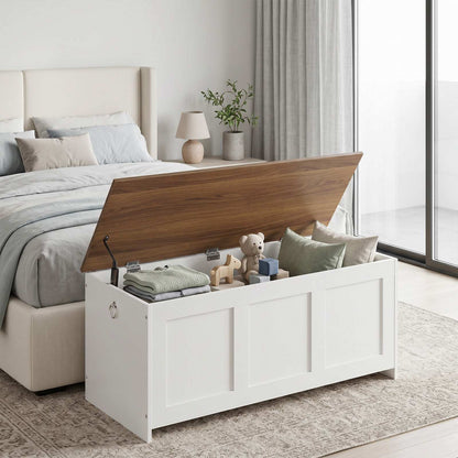 White farmhouse storage bench positioned seamlessly at the end of a bedroom bed with the brown wooden lid lifted open.