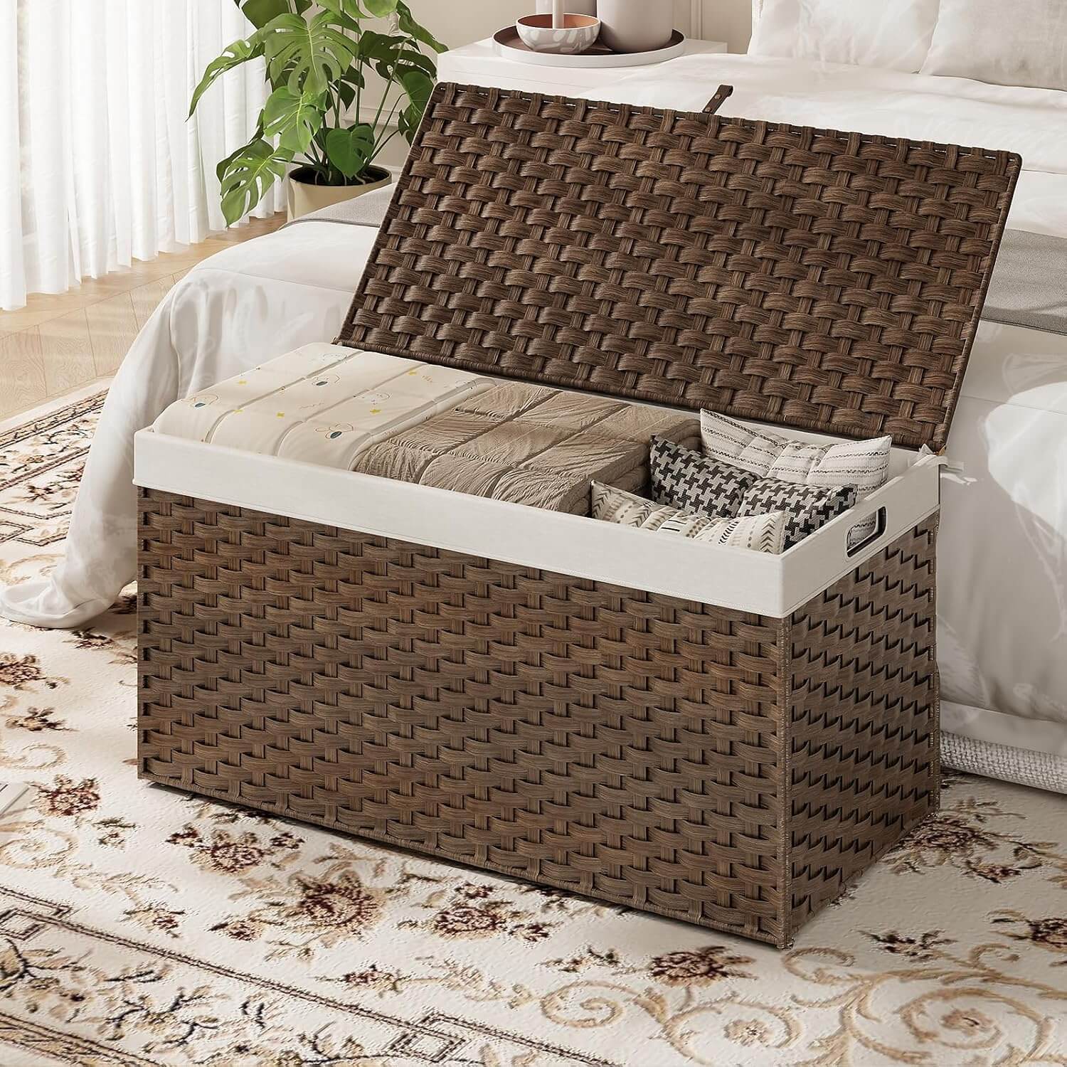 Woven storage bench with a white cushion in a bedroom setting
