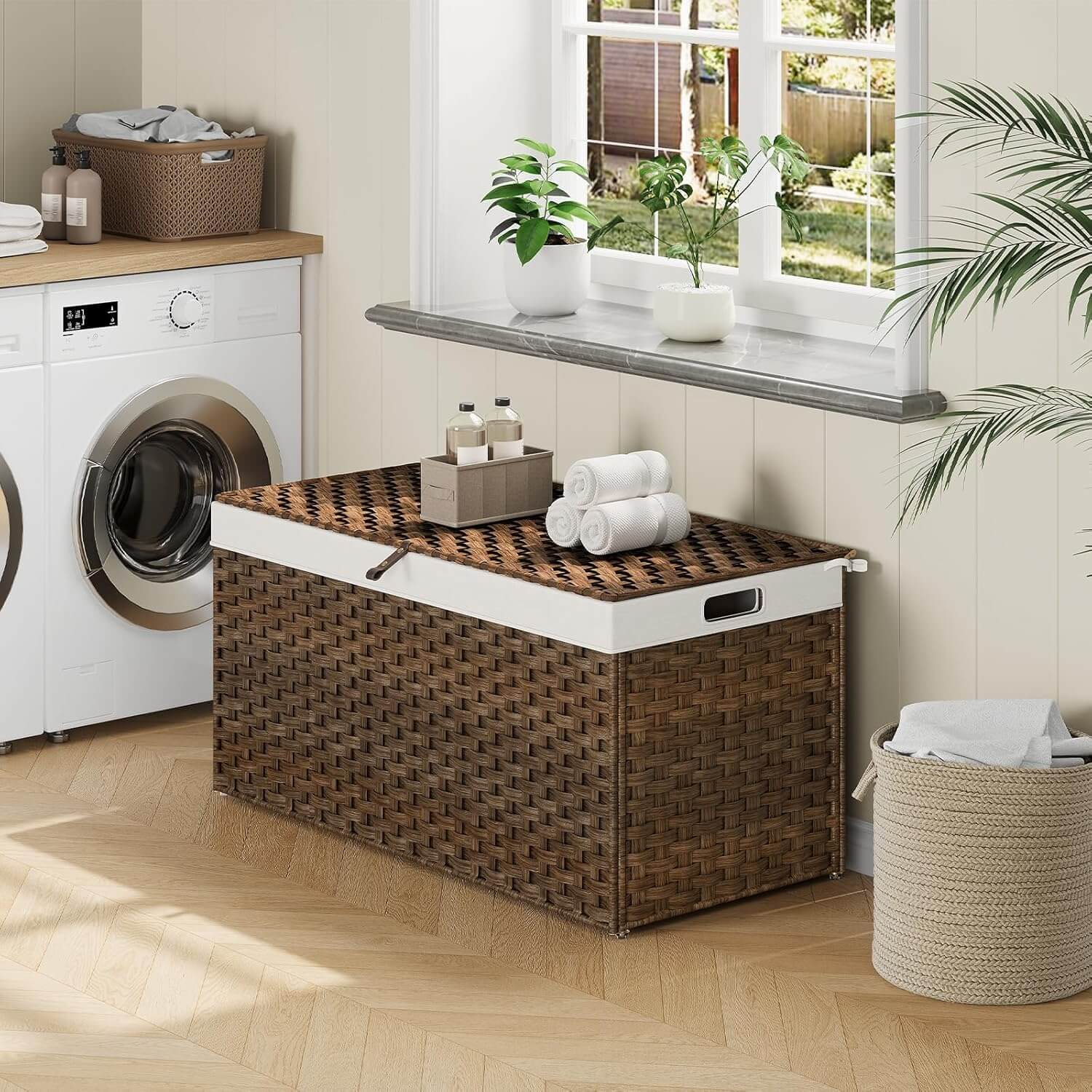 Laundry room with a woven storage basket, washing machine, and towels.